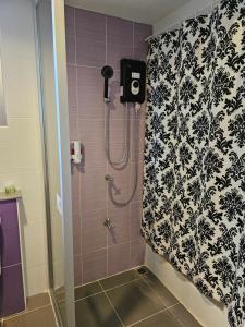 a bathroom with a shower with a black and white wallpaper at Baan Baimai Boutique Room in Phra Nakhon Si Ayutthaya +121 photos