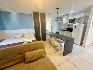 a living room with a couch and a kitchen at Wind Palace Residence in Cabedelo