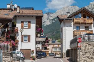 a street in a mountain town with a stop sign at Appartamento Cinzia in Moena