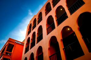 a building with arched windows on the side of it at Khaleej Mass Hotel Patong in Patong Beach
