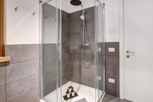 a shower with a glass door in a bathroom at Spark Chalet e Spa Livigno in Livigno +24 photos