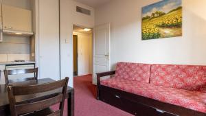 a living room with a couch and a table and a kitchen at Virginia N108 - 2P4 in Grasse