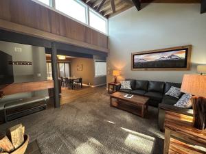 a living room with a couch and a table at 73 Meadow House in Sunriver