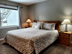 a bedroom with a large bed and a window at 73 Meadow House in Sunriver +18 photos