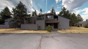 a large white house with a fence at 73 Meadow House in Sunriver