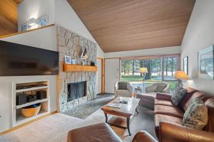 a living room with a couch and a fireplace at 76 Meadow House in Sunriver