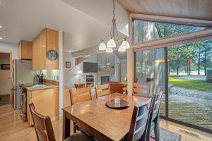 a kitchen and dining room with a table and chairs at 76 Meadow House in Sunriver