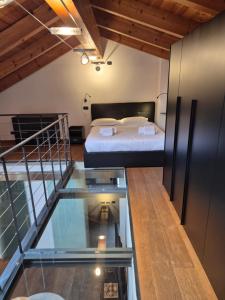 a room with a bed and a glass floor at Urban Loft Duomo in Alba