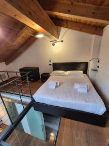 a bedroom with a bed in a room with wooden ceilings at Urban Loft Duomo in Alba