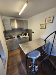 a kitchen with a sink and a counter top at Urban Loft Duomo in Alba