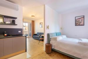 a hotel room with a bed and a kitchen at La Farmacia in Stresa