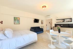 a bedroom with a white bed and a table and chairs at La Farmacia in Stresa