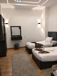 a hotel room with two beds and a tv at Karma Cairo Hotel in Cairo +32 photos