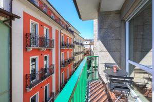 a balcony with a table and chairs on a building at La Farmacia in Stresa