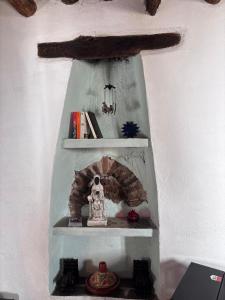 a shelf with a fireplace in a room at Casa Buena Vista in Ugíjar
