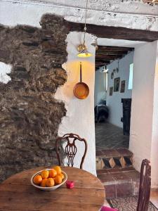 a bowl of oranges sitting on a wooden table at Casa Buena Vista in Ugíjar