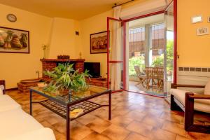 a living room with a glass table and a fireplace at Civic 55 in Toscolano Maderno