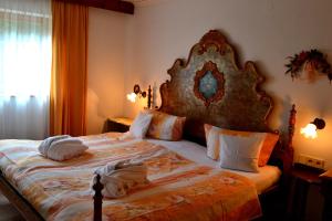 a bedroom with a large bed with pillows on it at Haus Bachschwalbe in Sasbachwalden