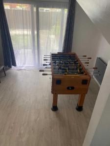 a foosball table in the middle of a room at Charming Contractors & Family Friendly 3-BR House in Harlow, Essex in Great Parndon
