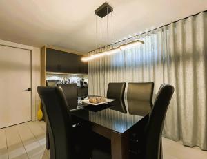 a dining room table with black chairs in a kitchen at Aubergélit in Saint-Jean-Port-Joli