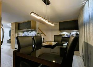 a kitchen and dining room with a table and chairs at Aubergélit in Saint-Jean-Port-Joli