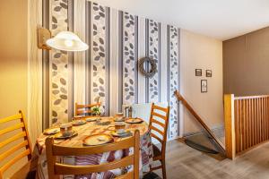 a dining room with a wooden table and chairs at Haus Dreeßen in Buchholz