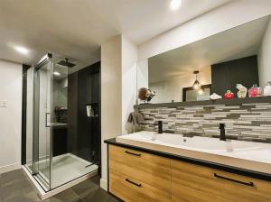 a bathroom with a large sink and a shower at Aubergélit in Saint-Jean-Port-Joli