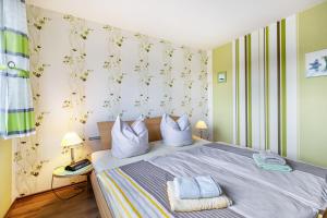a bedroom with a bed with two pillows on it at Haus Dreeßen in Buchholz