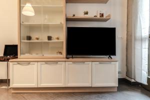 a large entertainment center with a flat screen tv at Beb Pulcino Nero Foiano in Foiano della Chiana