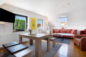 a living room with a couch and a table at Ferienwohnung Spallholtz in Stralsund