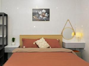 a bedroom with a bed with a mirror on the wall at Sky Home in Da Lat +7 photos
