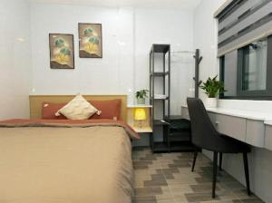 a bedroom with a bed and a desk and a desk at Sky Home in Da Lat