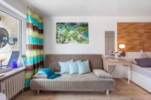 a living room with a couch and a table at Ferienappartement Magjar in Küssaberg