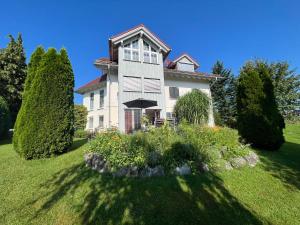 a large house with a garden in front of it at Sonnenhang in Sigmarszell