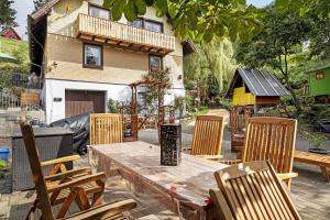 a patio with a wooden table and chairs at Haus Antonis in Triberg