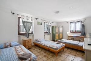 a room with three beds and a table in it at Knödelhof in Putzbrunn