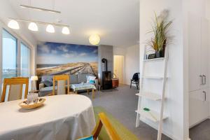a living room with a table and a couch at Seeschwalbe in Olpenitz
