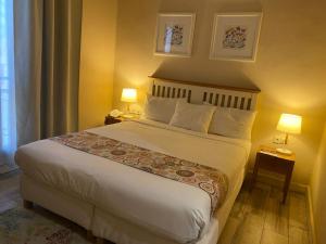 a hotel room with a bed and two lamps at The Best Centric Hotel in Nouakchott