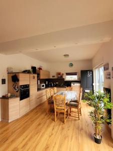 a kitchen and dining room with a table and chairs at Ferienhaus Schw Agnes in Warin