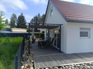 a white house with a wooden deck at Ferienhaus Schw Agnes in Warin