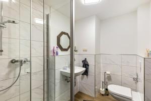 a bathroom with a shower and a sink at Fewo45 in Homberg +14 photos