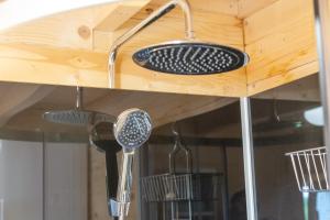 a kitchen sink with utensils hanging from a wooden counter at Chalet 5 personnes, proche canal in Landeleau