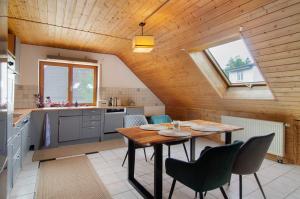 a kitchen with a table and chairs in a room at Jogis Paradies In Ruhiger Lage in Stockach