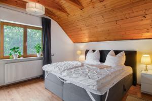 a bedroom with a large bed with a wooden ceiling at Jogis Paradies In Ruhiger Lage in Stockach