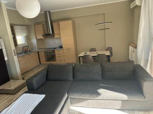 a living room with a couch and a kitchen at JD Maisonette for 4 in Neoi Epivates +10 photos