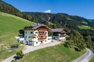 an aerial view of a house on a hill at Kreuzplonhof Apt Karspitz in Luson