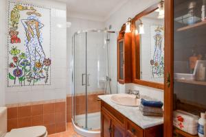 a bathroom with a shower and a sink at Villa Rústica con piscina privada in Tías +18 photos