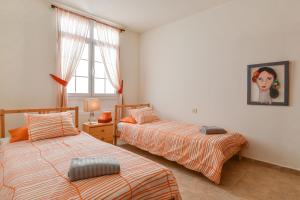 a bedroom with two beds and a girl on the wall at Villa Rústica con piscina privada in Tías
