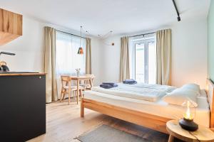 a bedroom with a large bed and a table at Alte Seifensiederei - Jane in Bad Tölz