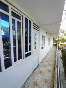 a hallway of a white building with windows at Refugio Del Mar in Burrero